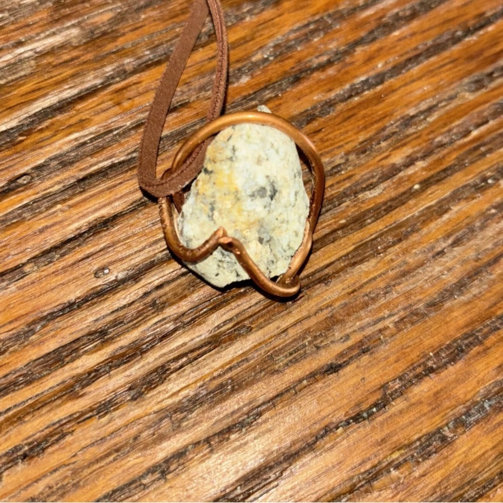 Hand wrapped Tennessee rock wrapped in copper wit leather rope.